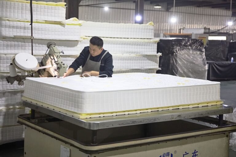 worker assembling memory foam mattress in China factory