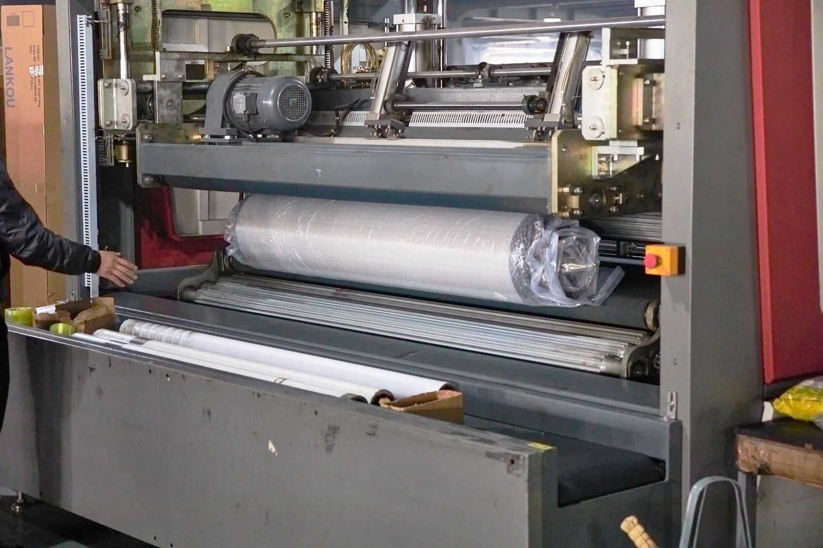 Mattress Being Compressed by Rolling Machine