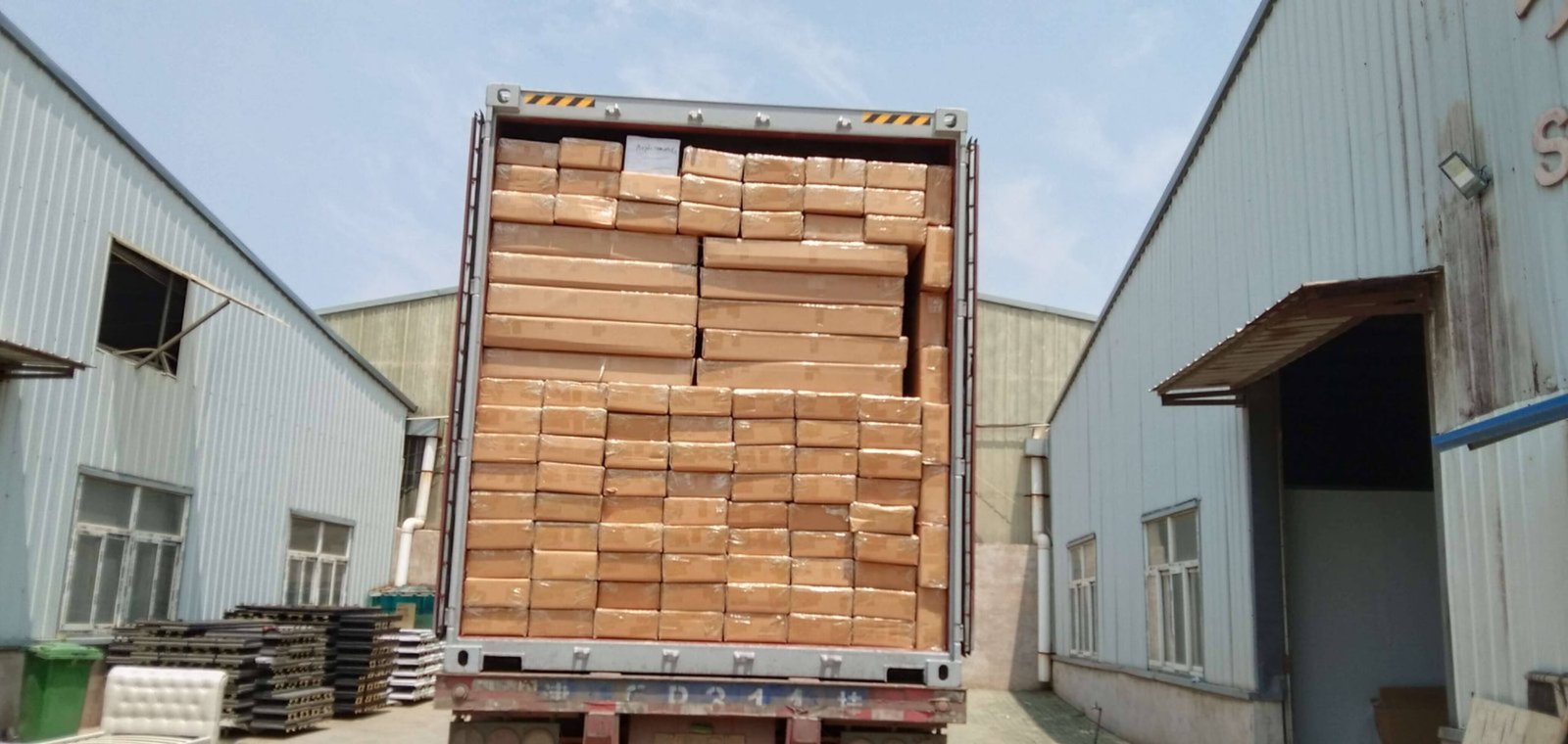 Knock-down bed frames for shipping Flat-packed bed frames being loaded efficiently into a container