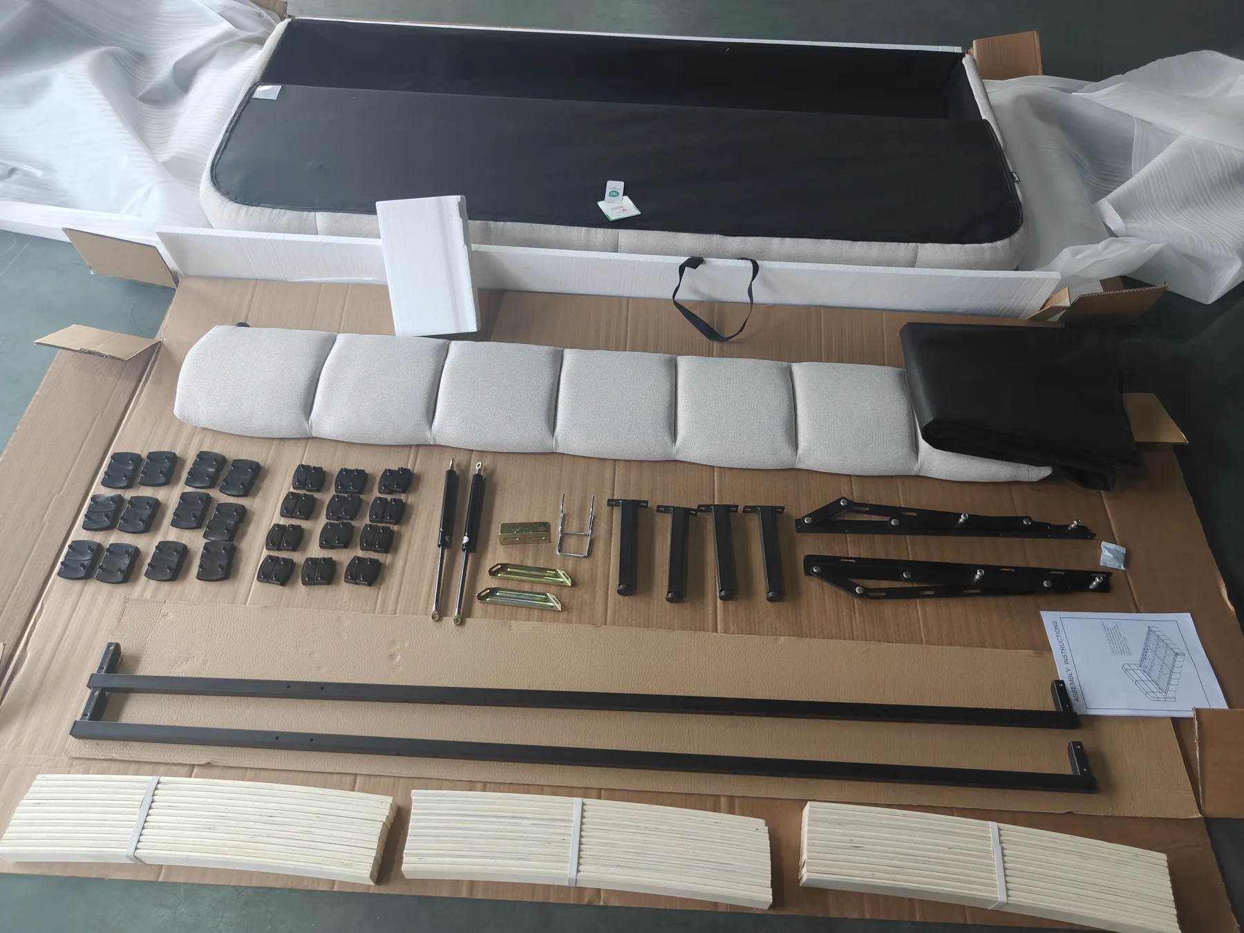 Upholstered ottoman storage bed assembled for pre-shipment QC