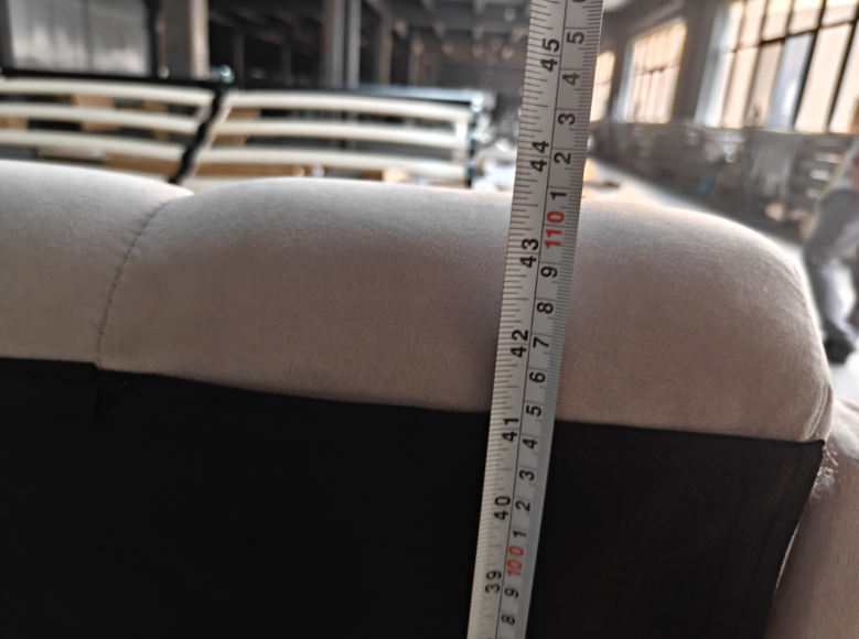 Measuring the dimensions of an upholstered bed during product inspection