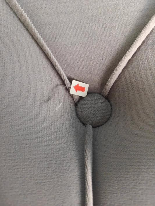 Loose thread on an upholstered headboard, marked in the inspection photograph