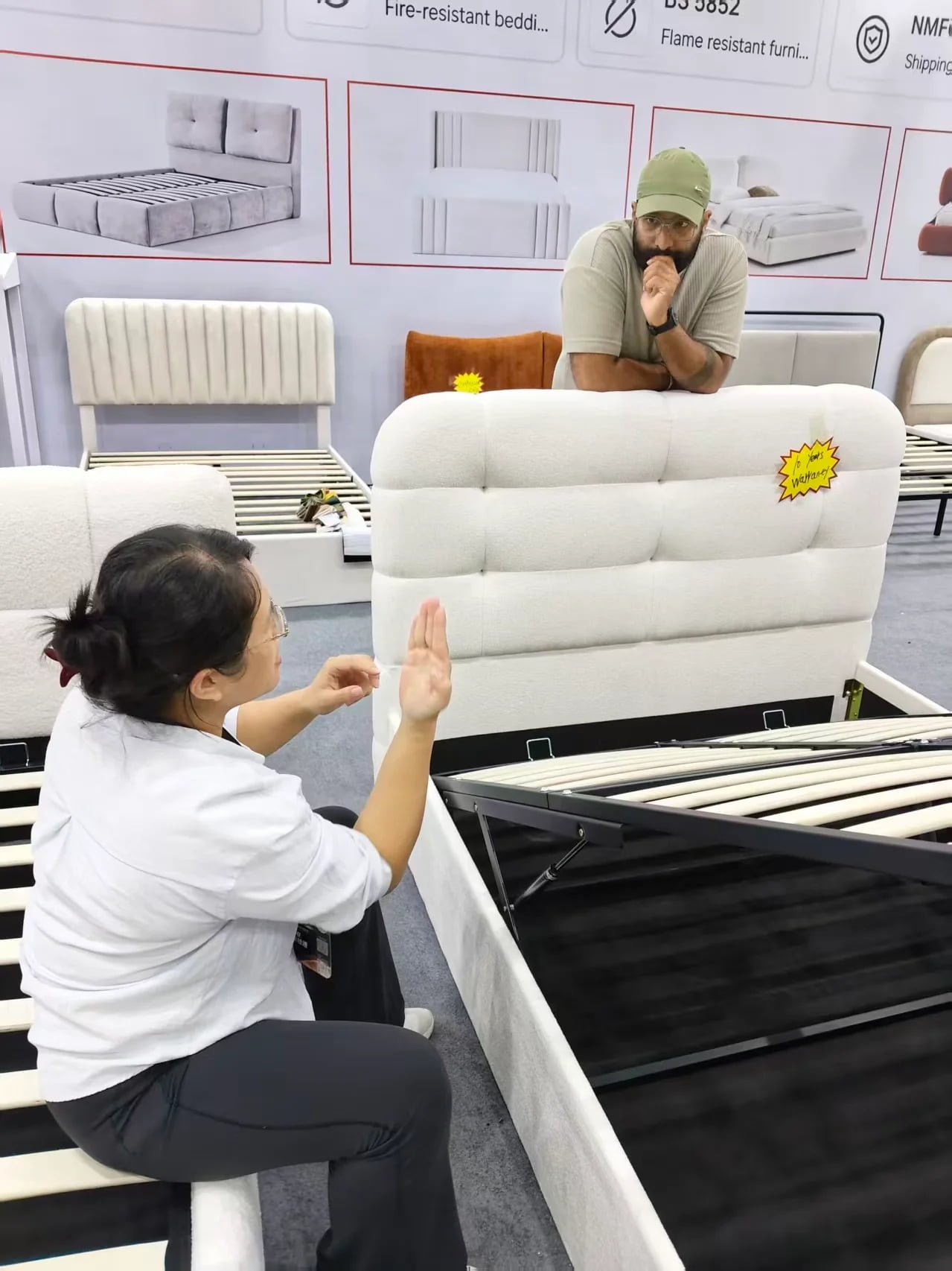 Sara discussing an ottoman bed base with a buyer