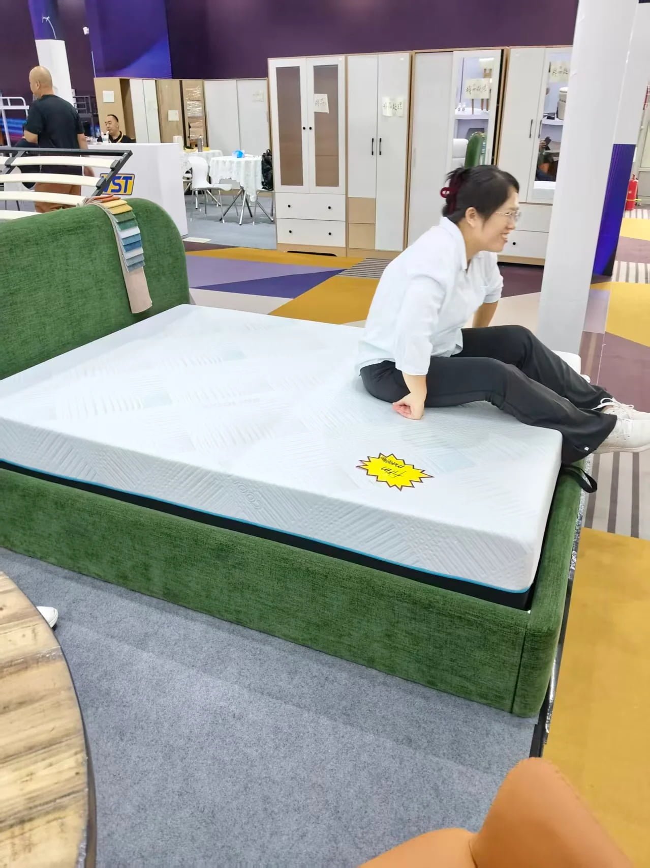 Sara demonstrating mattress comfort and rebound